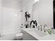 Well-lit bathroom showcasing a bathtub with a shower, white subway tile, and contemporary vanity with decor at 522 Pearl St, Cumming, GA 30040