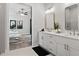 Bright bathroom featuring a double sink vanity with white cabinets and modern fixtures, blending with a bedroom view at 522 Pearl St, Cumming, GA 30040