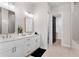 Double sink bathroom vanity with white cabinets, a walk-in closet and a walk-in shower at 522 Pearl St, Cumming, GA 30040