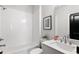 Clean bathroom featuring a tub with white subway tiles, modern vanity, and neutral decor, creating a serene atmosphere at 522 Pearl St, Cumming, GA 30040