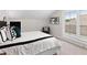 Cozy bedroom featuring a window with blinds, a stylish bed, and decor, creating a tranquil sleeping space at 522 Pearl St, Cumming, GA 30040