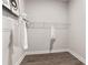 A simple closet with white wire shelving and hanging space, ideal for storage and organization at 522 Pearl St, Cumming, GA 30040