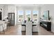 Bright dining area features lots of windows, modern lighting, and stainless steel refrigerator at 522 Pearl St, Cumming, GA 30040