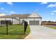 New construction featuring a pristine driveway, fenced yard, and a two-car garage at 522 Pearl St, Cumming, GA 30040