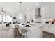 Stylish kitchen with white cabinets, a large island, and seamless flow to the living area with sliding glass doors at 522 Pearl St, Cumming, GA 30040