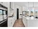 Modern kitchen showcasing white cabinetry, stainless steel appliances, and a large island with pendant lighting at 522 Pearl St, Cumming, GA 30040