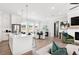 Bright open-concept living room with hardwood floors, modern white kitchen and adjacent dining area at 522 Pearl St, Cumming, GA 30040