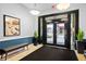 Building entryway featuring a bench, plants, and modern lighting, creating a welcoming and stylish first impression at 800 Peachtree Ne St # 8509, Atlanta, GA 30308