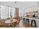 Charming dining area with a round table, chairs, and natural light from large windows, located near the kitchen at 800 Peachtree Ne St # 8509, Atlanta, GA 30308