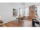 Cozy dining area with a round table, four chairs, and natural light from large windows, next to the kitchen bar at 800 Peachtree Ne St # 8509, Atlanta, GA 30308