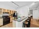 Bright kitchen features stainless appliances, granite counters, wood floors and breakfast bar with seating at 800 Peachtree Ne St # 8509, Atlanta, GA 30308