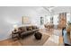 Inviting living room with hardwood floors, neutral tones, and exposed brick, providing a comfortable and stylish space at 800 Peachtree Ne St # 8509, Atlanta, GA 30308