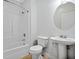 This bathroom features a tub shower and a pedestal sink at 1283 Mercer Ave, East Point, GA 30344
