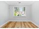 This bedroom features a window that lets in natural light and wood-look flooring at 1283 Mercer Ave, East Point, GA 30344