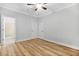 This bedroom features two closets, a ceiling fan, and wood-look flooring, with an ensuite bathroom at 1283 Mercer Ave, East Point, GA 30344