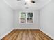 This is a bedroom featuring a ceiling fan, a window letting in natural light, and wood-look flooring at 1283 Mercer Ave, East Point, GA 30344