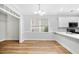 Dining area featuring hardwood floors, neutral paint, a large window, and a view to the kitchen at 1283 Mercer Ave, East Point, GA 30344