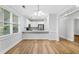 Dining room with a breakfast bar looking into the kitchen, complemented by neutral paint, hardwood floors, and lots of light at 1283 Mercer Ave, East Point, GA 30344