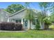 Charming home featuring fresh landscaping and a welcoming front porch with light blue door and trim at 1283 Mercer Ave, East Point, GA 30344