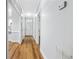 Bright hallway featuring hardwood floors and a modern design leading to the front door and other rooms at 1283 Mercer Ave, East Point, GA 30344