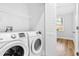 This is a bright laundry room featuring side-by-side washer and dryer and built-in shelving at 1283 Mercer Ave, East Point, GA 30344