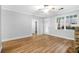 Spacious living room showcasing hardwood floors, a stone fireplace, and ample natural light from multiple windows at 1283 Mercer Ave, East Point, GA 30344