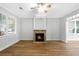 Inviting living room featuring a fireplace and hardwood floors, illuminated by natural light from large windows at 1283 Mercer Ave, East Point, GA 30344