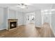 Bright living room with wood flooring, stone fireplace, ceiling fan, and plenty of natural light at 1283 Mercer Ave, East Point, GA 30344