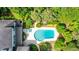 Aerial view showcases a private pool and patio area, surrounded by lush landscaping and mature trees at 1550 Masters Club Dr, Sandy Springs, GA 30350