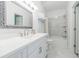 Bathroom featuring white cabinets, marble countertops, modern fixtures, and a shower-tub combo at 1550 Masters Club Dr, Sandy Springs, GA 30350