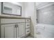 Elegant bathroom with a granite-topped vanity and decorative mirror, next to a shower/tub combination at 1550 Masters Club Dr, Sandy Springs, GA 30350