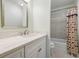 Bathroom featuring a white vanity, neutral walls, a shower-tub combo, and themed shower curtain at 1550 Masters Club Dr, Sandy Springs, GA 30350
