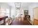 Elegant dining room featuring stylish chairs, hardwood floors, and plenty of natural light at 1550 Masters Club Dr, Sandy Springs, GA 30350