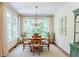 Bright dining room with a garden view features an elegant chandelier and seating for four at 1550 Masters Club Dr, Sandy Springs, GA 30350