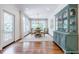 Dining room with hard wood floors, bright windows, an antique china cabinet, and round dining table at 1550 Masters Club Dr, Sandy Springs, GA 30350