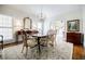 Elegant dining room with stylish chairs, chandelier, and hardwood floors for sophisticated gatherings at 1550 Masters Club Dr, Sandy Springs, GA 30350