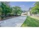 Long driveway leading to a charming home with well-manicured landscaping, offering privacy and curb appeal at 1550 Masters Club Dr, Sandy Springs, GA 30350