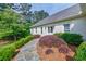 Elegant, one-story brick home featuring a lush front yard and landscaped walkway at 1550 Masters Club Dr, Sandy Springs, GA 30350