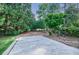 Extended parking pad, providing space for multiple vehicles, surrounded by verdant landscaping at 1550 Masters Club Dr, Sandy Springs, GA 30350
