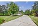 Inviting driveway leads to a beautiful home, surrounded by lush greenery, showcasing excellent curb appeal at 1550 Masters Club Dr, Sandy Springs, GA 30350
