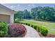 Charming brick home with a walkway leading to the entrance and a well-manicured lawn at 1550 Masters Club Dr, Sandy Springs, GA 30350