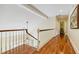 Hallway featuring hardwood floors, a staircase with wood railing, and chandelier at 1550 Masters Club Dr, Sandy Springs, GA 30350