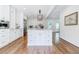 Bright kitchen features stainless appliances, white cabinets, and an island with marble countertops at 1550 Masters Club Dr, Sandy Springs, GA 30350