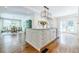 Kitchen island with stainless steel appliances, granite countertops, and hardwood floors, open to dining at 1550 Masters Club Dr, Sandy Springs, GA 30350