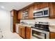 Well-equipped kitchenette with stainless steel appliances, granite counters, and wooden cabinets at 1550 Masters Club Dr, Sandy Springs, GA 30350