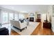 Open living room with hardwood floors, neutral colors, large windows, and a cozy fireplace at 1550 Masters Club Dr, Sandy Springs, GA 30350