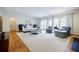 Spacious living room with large windows, an area rug, hardwood floors, and comfortable seating arrangements at 1550 Masters Club Dr, Sandy Springs, GA 30350