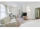 Bright main bedroom features a sitting area, an ensuite bathroom, and neutral decor at 1550 Masters Club Dr, Sandy Springs, GA 30350
