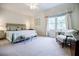 Serene main bedroom with large windows, a king-size bed, and elegant decor at 1550 Masters Club Dr, Sandy Springs, GA 30350
