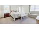 Light filled main bedroom with a four poster bed, love seat, and ample natural light at 1550 Masters Club Dr, Sandy Springs, GA 30350